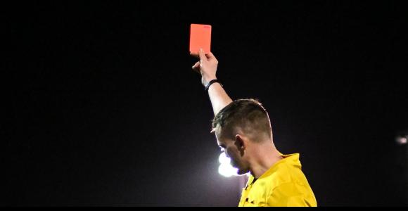ref holding a yellow card